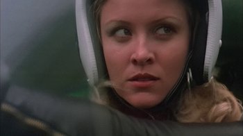 Movie still from “Death Race 2000” (1975), directed by Paul Bartel – A person wearing headphones; Close Up shot, Low angle