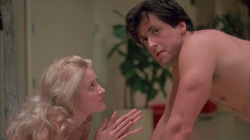 Movie still from “Death Race 2000” (1975), directed by Paul Bartel – A man and a woman are looking at one another; Medium shot, Low angle