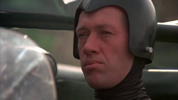 Movie still from “Death Race 2000” (1975), directed by Paul Bartel – A person wearing a helmet; Close Up shot, Low angle
