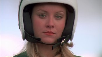 Movie still from “Death Race 2000” (1975), directed by Paul Bartel – A person wearing a motorcycle helmet; Close Up shot, Low angle