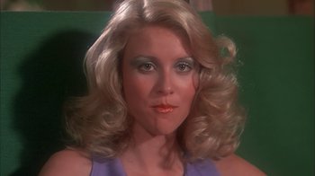 Movie still from “Death Race 2000” (1975), directed by Paul Bartel – A person wearing a purple shirt; Close Up shot, Low angle