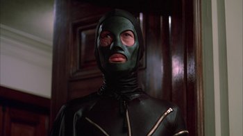 Movie still from “Death Race 2000” (1975), directed by Paul Bartel – A man in a green mask and a leather suit; Close Up shot, Low angle