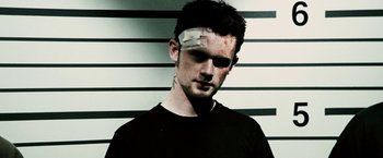 Movie still from “Death Sentence” (2007), directed by James Wan – A man with a bandage on his forehead; Close Up shot, Low angle