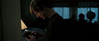 Movie still from “Death Sentence” (2007), directed by James Wan – A young man looking down at a guitar; Close Up shot, Low angle