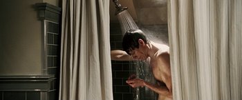 Movie still from “Death Sentence” (2007), directed by James Wan – A man is taking a shower in the bathroom; Medium shot, Low angle