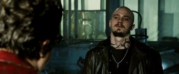Movie still from “Death Sentence” (2007), directed by James Wan – A man in a leather jacket with a cross on his chest; Close Up shot, Low angle