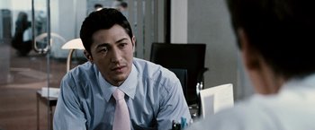 Movie still from “Death Sentence” (2007), directed by James Wan – A man sitting at a table in a room; Close Up shot, Over the shoulder angle