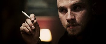 Movie still from “Death Sentence” (2007), directed by James Wan – A person holding something in his hand; Close Up shot, Low angle