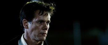 Movie still from “Death Sentence” (2007), directed by James Wan – A person wearing a black shirt; Close Up shot, Low angle