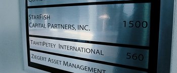 Movie still from “Death Sentence” (2007), directed by James Wan – The company name sign on a wall; Medium shot, Low angle