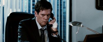 Movie still from “Death Sentence” (2007), directed by James Wan – A man talking on a phone while wearing a suit; Close Up shot, High angle