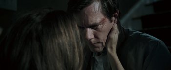 Movie still from “Death Sentence” (2007), directed by James Wan – A man and a woman face to face in a dark room; Close Up shot, Over the shoulder angle