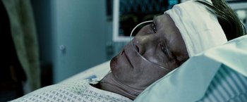 Movie still from “Death Sentence” (2007), directed by James Wan – An older man is laying in a hospital bed; Close Up shot, High angle