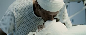 Movie still from “Death Sentence” (2007), directed by James Wan – A man and a woman kissing in a hospital bed; Extreme Close Up shot, Over the shoulder angle