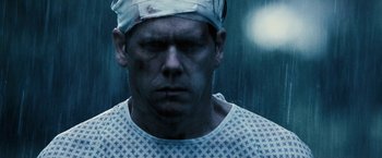 Movie still from “Death Sentence” (2007), directed by James Wan – A person with a bandage on his head; Close Up shot, Over the shoulder angle