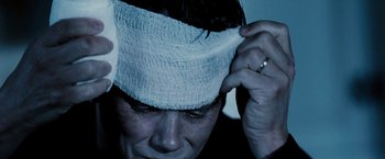 Movie still from “Death Sentence” (2007), directed by James Wan – A man with a bandage on his head; Extreme Close Up shot, Overhead angle