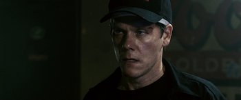 Movie still from “Death Sentence” (2007), directed by James Wan – A person wearing a hat; Close Up shot, Over the shoulder angle
