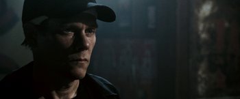 Movie still from “Death Sentence” (2007), directed by James Wan – A person wearing a hat; Close Up shot, Over the shoulder angle