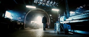 Movie still from “Death Sentence” (2007), directed by James Wan – A man standing in front of an arched doorway; Wide shot, Low angle