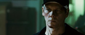 Movie still from “Death Sentence” (2007), directed by James Wan – A person wearing a hat; Close Up shot, Over the shoulder angle