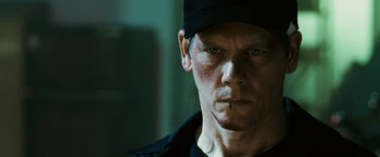 Movie still from “Death Sentence” (2007), directed by James Wan – A person wearing a hat; Close Up shot, Over the shoulder angle