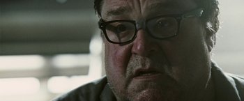Movie still from “Death Sentence” (2007), directed by James Wan – An older man wearing glasses looking at the camera; Close Up shot, Low angle