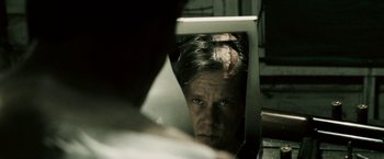Movie still from “Death Sentence” (2007), directed by James Wan – A man looking at himself in a mirror; Close Up shot, Over the shoulder angle