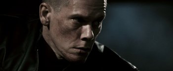 Movie still from “Death Sentence” (2007), directed by James Wan – A man's face in the dark; Close Up shot, Low angle