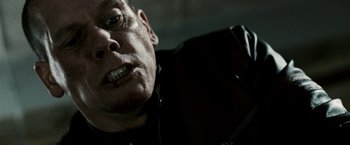 Movie still from “Death Sentence” (2007), directed by James Wan – A man's face in a black jacket; Close Up shot, Low angle