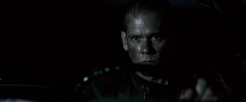 Movie still from “Death Sentence” (2007), directed by James Wan – A person wearing a black jacket; Close Up shot, Over the shoulder angle