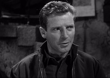 Movie still from “Decision Before Dawn” (1951), directed by Anatole Litvak – Black and white photograph of a man in a black jacket; Close Up shot, Low angle