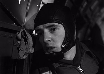 Movie still from “Decision Before Dawn” (1951), directed by Anatole Litvak – Black and white photograph of a man wearing a helmet; Close Up shot, Low angle