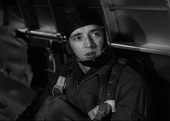 Movie still from “Decision Before Dawn” (1951), directed by Anatole Litvak – A black and white photo of a man wearing a helmet; Close Up shot, Low angle