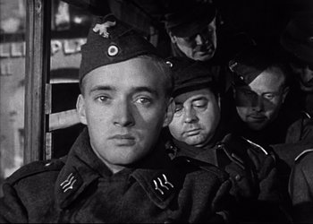 Movie still from “Decision Before Dawn” (1951), directed by Anatole Litvak – Black and white photograph of a man in military uniform; Close Up shot, Low angle