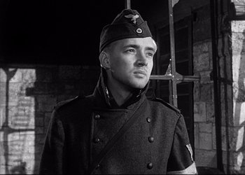 Movie still from “Decision Before Dawn” (1951), directed by Anatole Litvak – Black and white photograph of a man in a military uniform; Close Up shot, Low angle