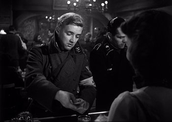 Movie still from “Decision Before Dawn” (1951), directed by Anatole Litvak – A black and white photo of a man and a woman; Medium shot, Low angle