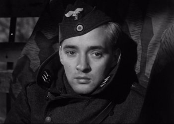 Movie still from “Decision Before Dawn” (1951), directed by Anatole Litvak – A black and white photo of a man in a military uniform; Close Up shot, Low angle