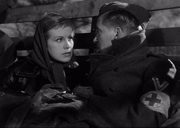 Movie still from “Decision Before Dawn” (1951), directed by Anatole Litvak – A man and a woman are sitting on a park bench; Close Up shot, Low angle