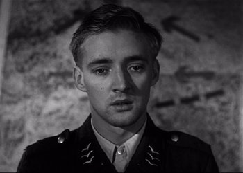 Movie still from “Decision Before Dawn” (1951), directed by Anatole Litvak – Black and white photograph of a man in military uniform; Close Up shot, High angle
