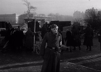 Movie still from “Decision Before Dawn” (1951), directed by Anatole Litvak – An older man in a military uniform standing in front of a crowd; Medium shot, Low angle