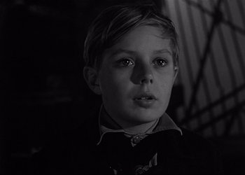 Movie still from “Decision Before Dawn” (1951), directed by Anatole Litvak – A young boy is looking at the camera; Close Up shot, High angle