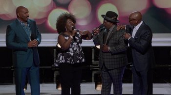 A couple of people that are singing on a stage