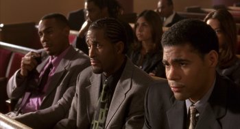 Movie still from “Deliver Us from Eva” (2003), directed by Gary Hardwick – A group of people in suits and ties sitting in a room; Close Up shot, High angle