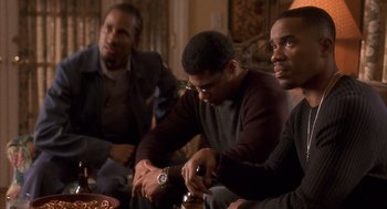 Movie still from “Deliver Us from Eva” (2003), directed by Gary Hardwick – A group of men sitting around a table; Medium shot, High angle