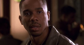 Movie still from “Deliver Us from Eva” (2003), directed by Gary Hardwick – A person wearing a leather jacket; Close Up shot, Low angle