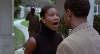 Movie still from “Deliver Us from Eva” (2003), directed by Gary Hardwick – A woman in a black shirt and a man in a black shirt; Close Up shot, Over the shoulder angle