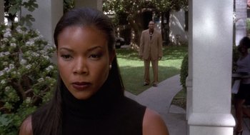 Movie still from “Deliver Us from Eva” (2003), directed by Gary Hardwick – A man and a woman standing in the grass; Medium shot, Over the shoulder angle