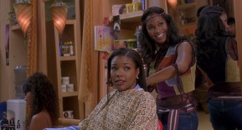 Movie still from “Deliver Us from Eva” (2003), directed by Gary Hardwick – Two young women are getting their hair done; Medium shot, Over the shoulder angle