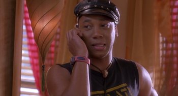 Movie still from “Deliver Us from Eva” (2003), directed by Gary Hardwick – A man wearing a hat talking on a cell phone; Close Up shot, Over the shoulder angle