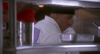 Movie still from “Deliver Us from Eva” (2003), directed by Gary Hardwick – A man wearing a white shirt and a black hat; Close Up shot, Low angle